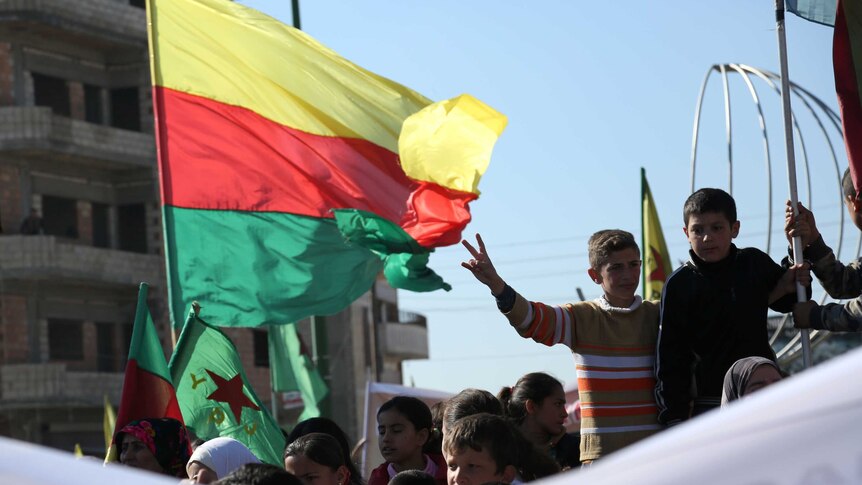 The YPG Kurdish flag waves at a protest.