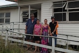 Andrew and Michelle Cooney with their family outside their home in Bargara