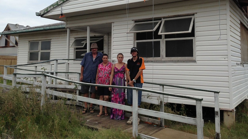 Andrew and Michelle Cooney with their family outside their home in Bargara