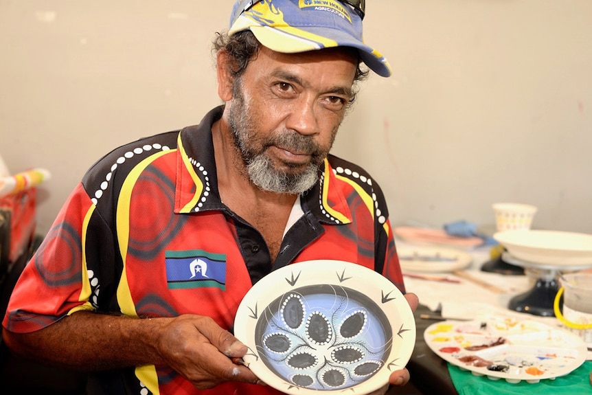 Cherbourg artist Maurice Mickelo with one of his ceramic pieces.
