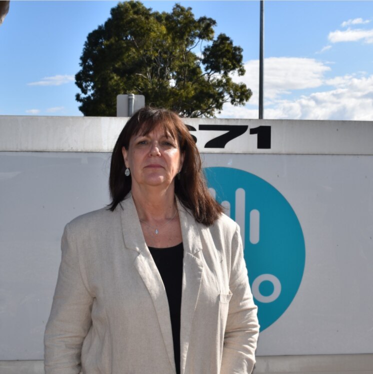 A businesswoman standing outside a science facility