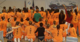 Female prisoners wearing orange jumpsuits
