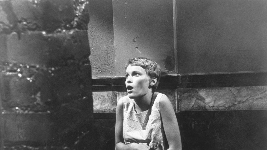 Mia Farrow clutches her stomach in a scene from the 1968 film Rosemary's Baby