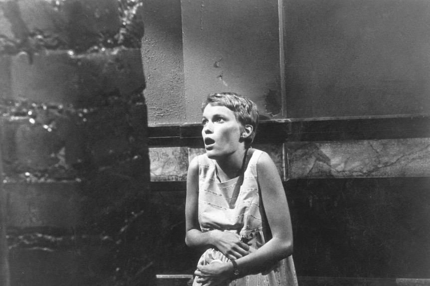 Mia Farrow clutches her stomach in a scene from the 1968 film Rosemary's Baby