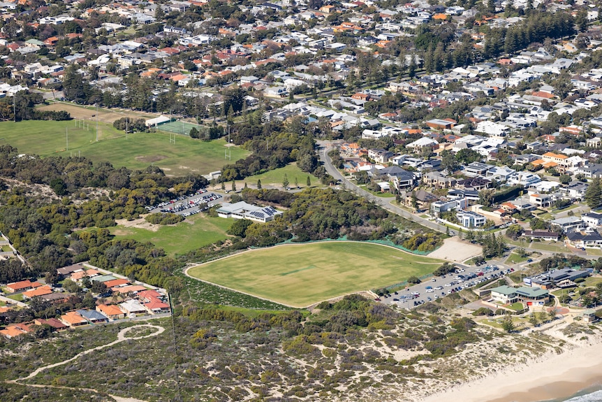 An aerial shot of a large green park. 