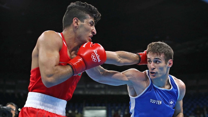 Canada's Arthur Biyarslanov (blue) was among the growing number of boxers who hit out at the officiating in Rio.
