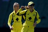 Kristen Beams (L) celebrates with Australia captain Meg Lanning after bowling out New Zealand's Erin Bermingham.