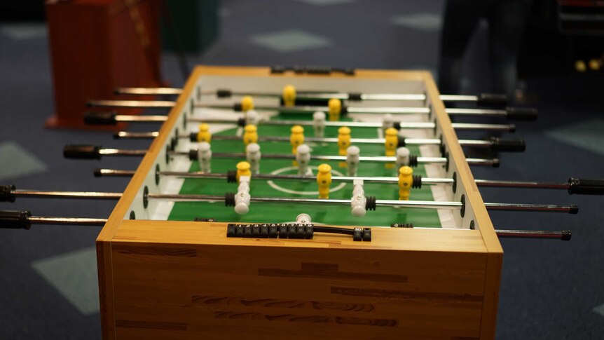 An end-to-end shot of a fusball table