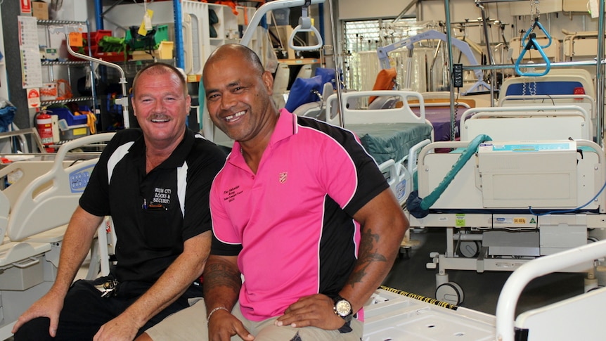 Lloyd Finnis and Moe Turaga surrounded by donated hospital beds