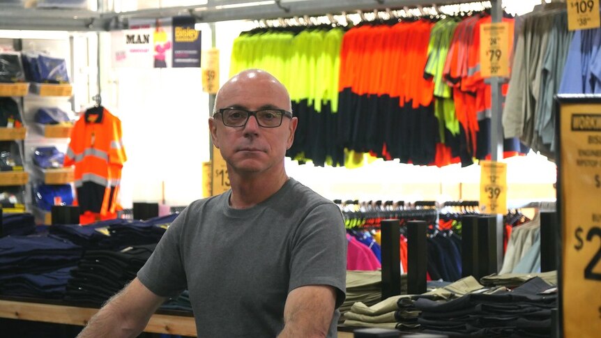 a man in a workwear store