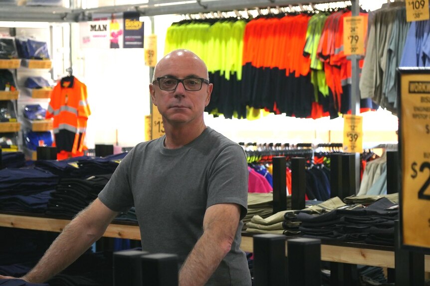 a man in a workwear store