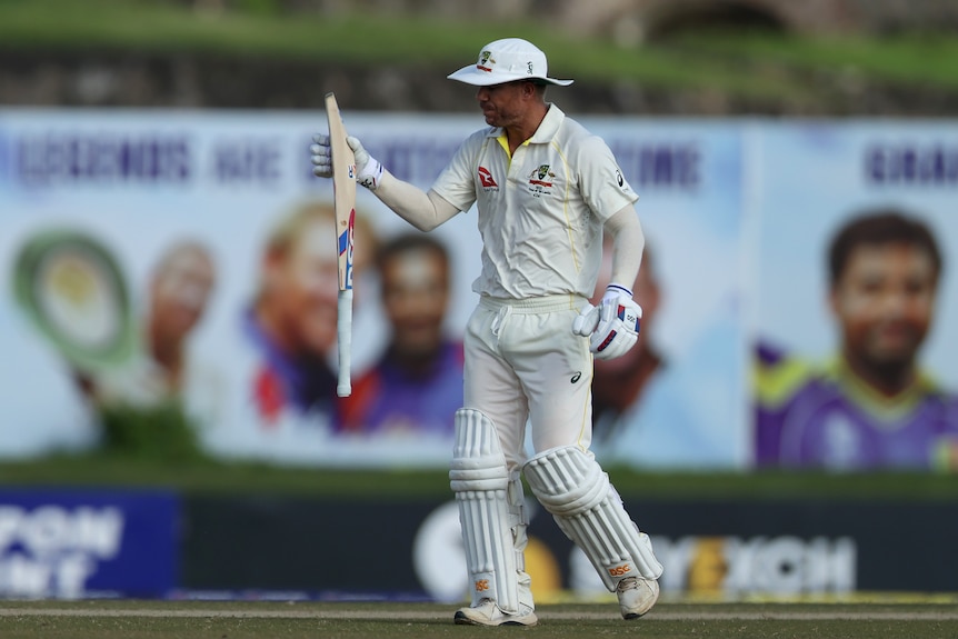 David Warner catches his bat with a disgusted look on his face after getting out in a Test against Sri Lanka.