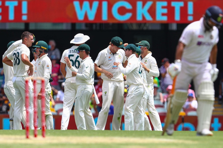 Australia celebrates the wicket of India's Rishabh Pant as he leaves the field.