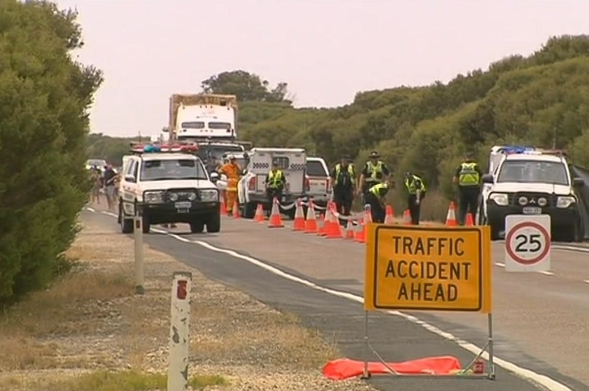 Police and SES stand on the road when a cyclist was hit by a car.