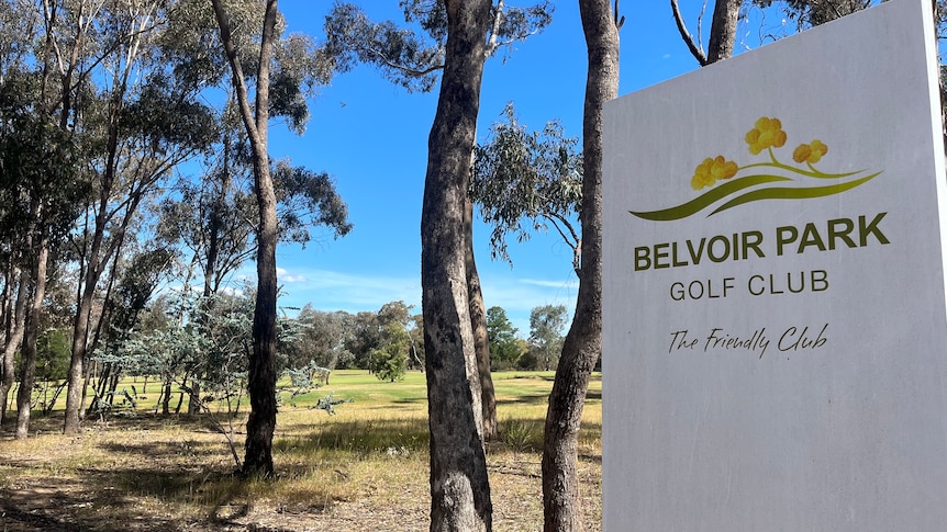 A sign saying Belvoir Park Golf Club in a bushland area.