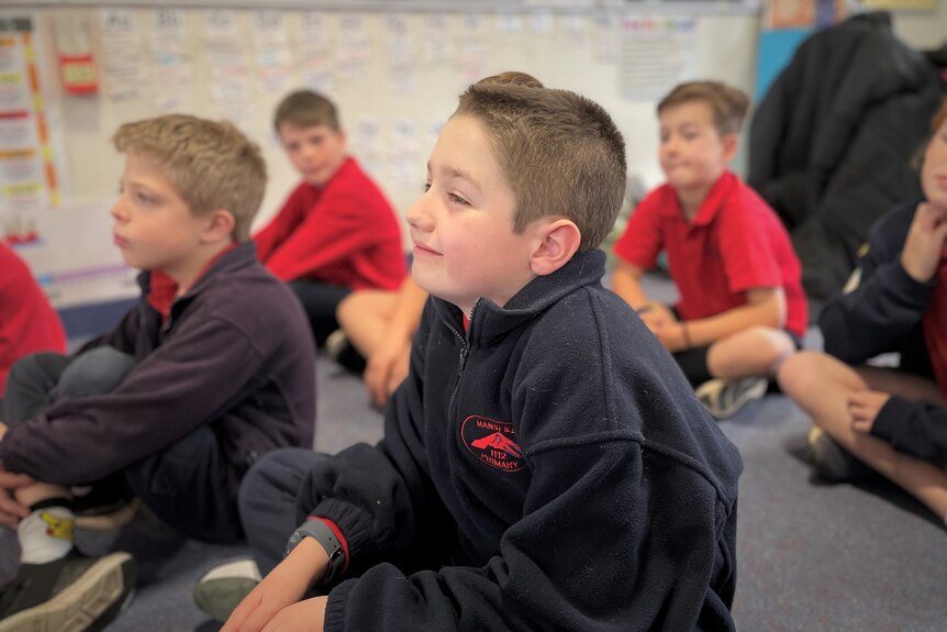 A boy sits in a classroom