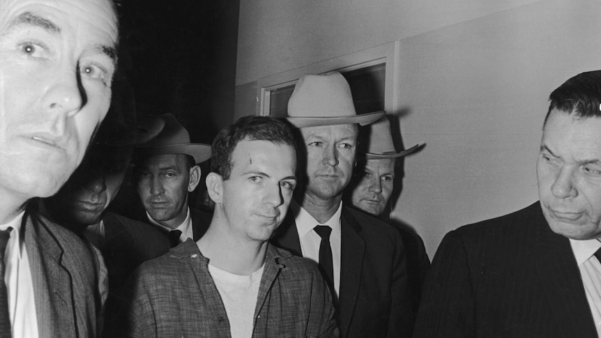 Three men two plain cloth policemen and a suspect Lee Harvey Oswald.