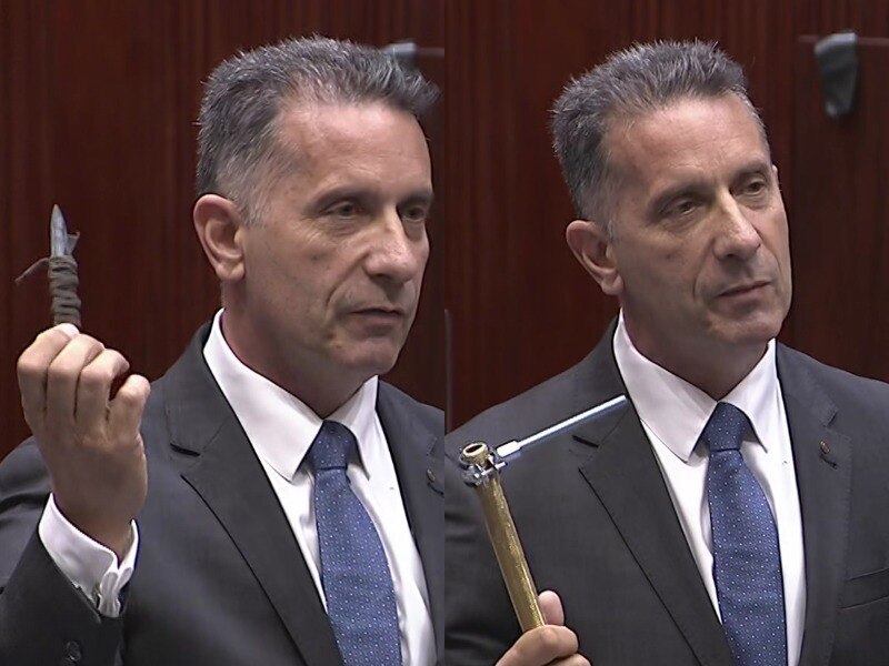 A man holding up weapons to his shoulder height