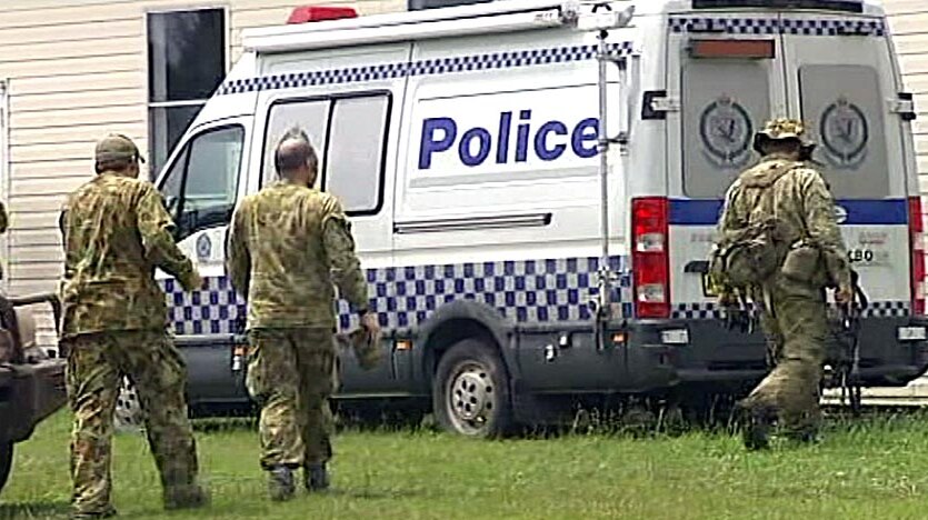 NSW Police in camouflage at Nowendoc, where they are on the hunt for Malcolm Naden.