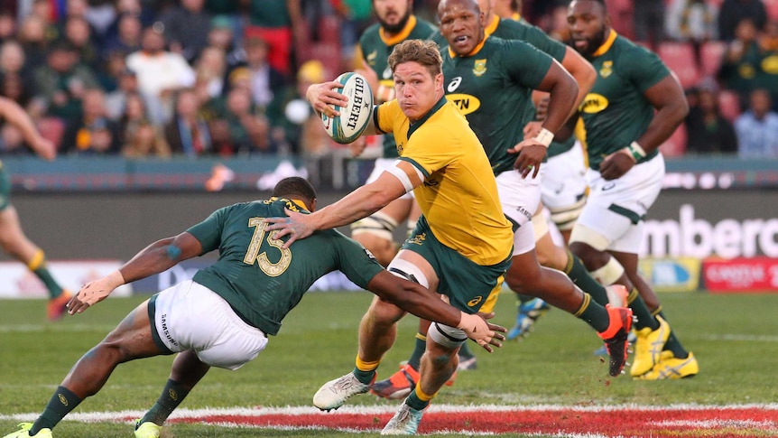 Michael Hooper looks to sidestep a Springboks tackle as he holds the ball