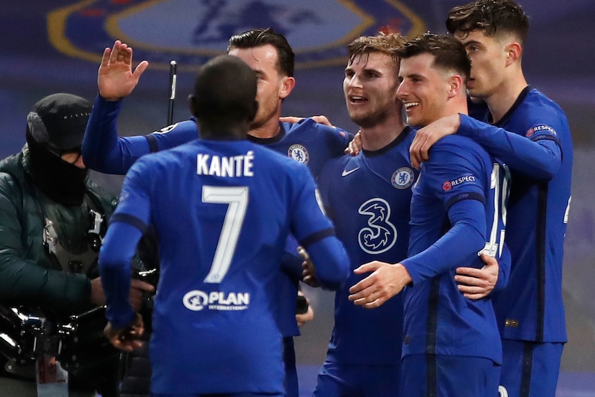 N'Golo Kante, seen from behind, runs to join his celebrating Chelsea teammates after a Champions League goal.