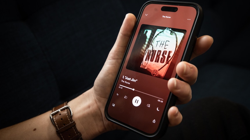 A hand holds a phone showing it playing episode 1 of The Nurse podcast.