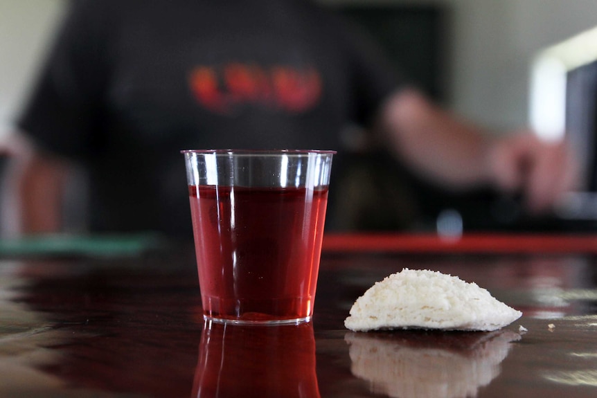 Cup of wine and bread on a table.