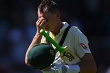 Marnus Labuschagne holds the bridge of his nose in frustration while walking off the field