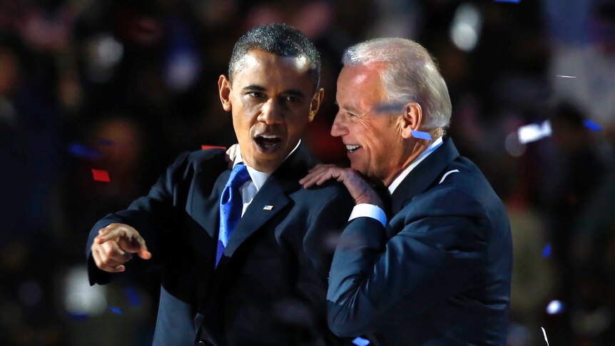 US President Barack Obama gestures with Vice President Joe Biden after his election night victory speech