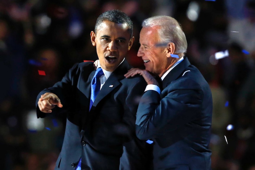 US President Barack Obama gestures with Vice President Joe Biden after his election night victory speech