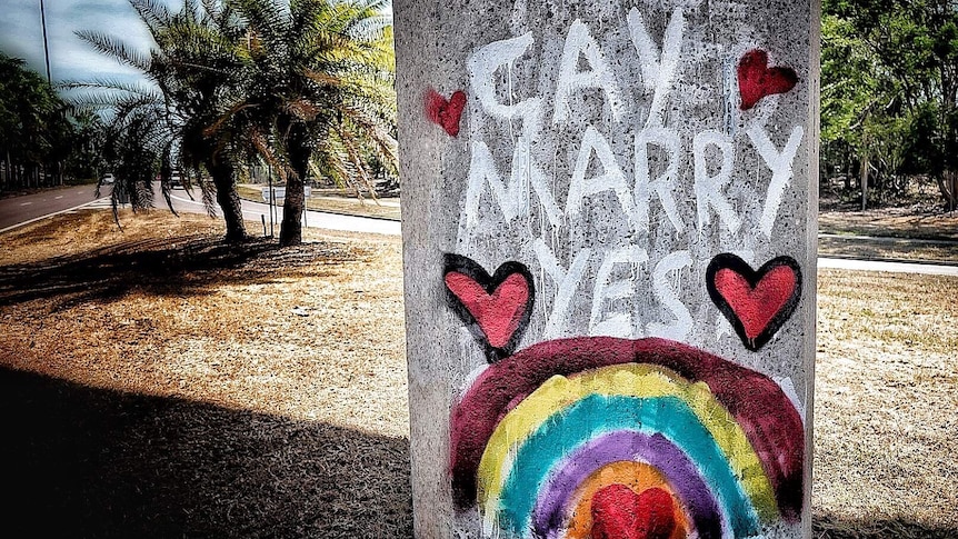 Graffiti in Darwin in favour of gay marriage covers homophobic slurs on a pylon