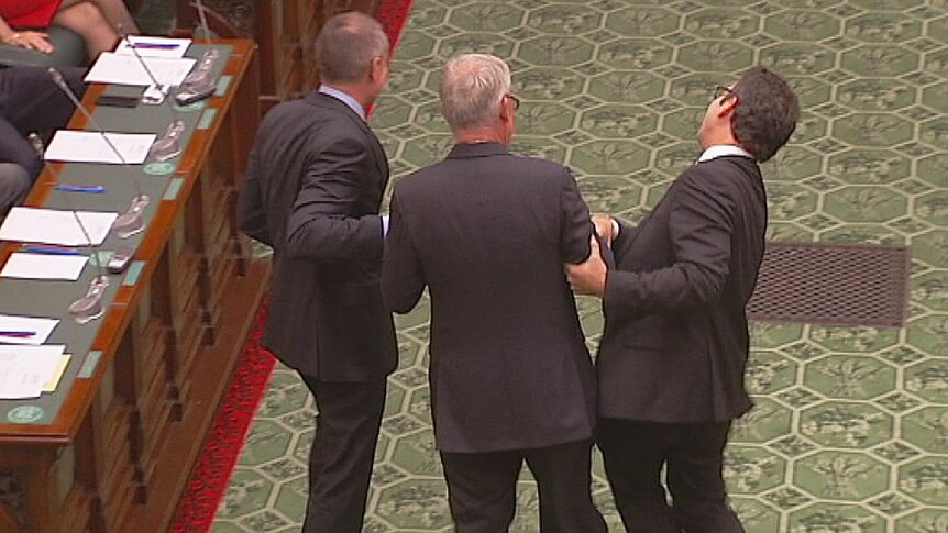 Premier and Opposition Leader drag Michael Atkinson to the chair