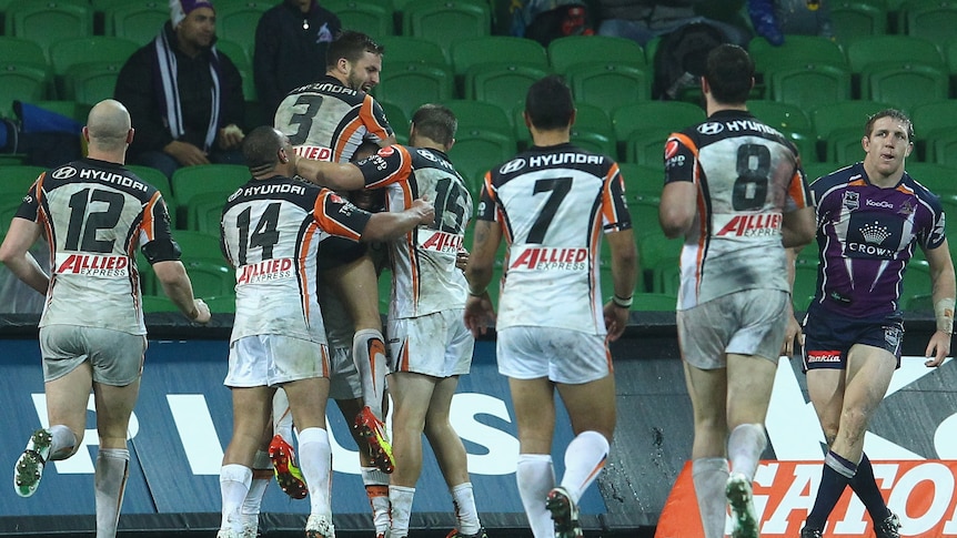 Seventh heaven ... the Tigers celebrate in the Melbourne rain at AAMI Park.