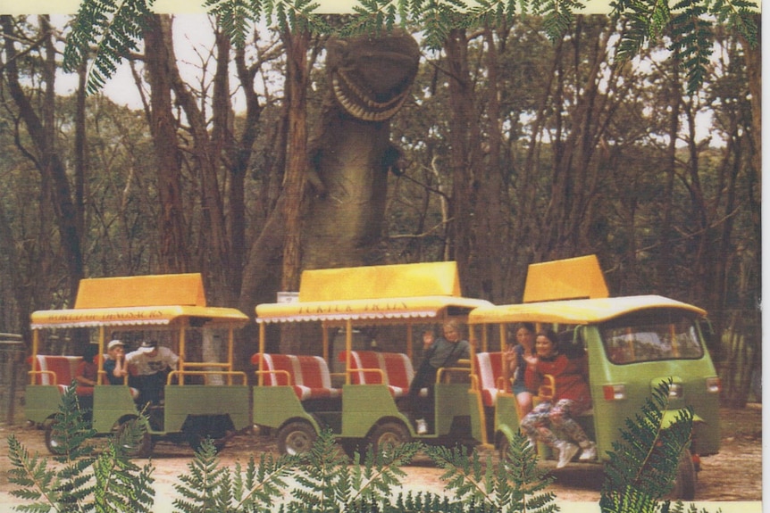 A novelty train ride passing the T-rex at the dinosaur park