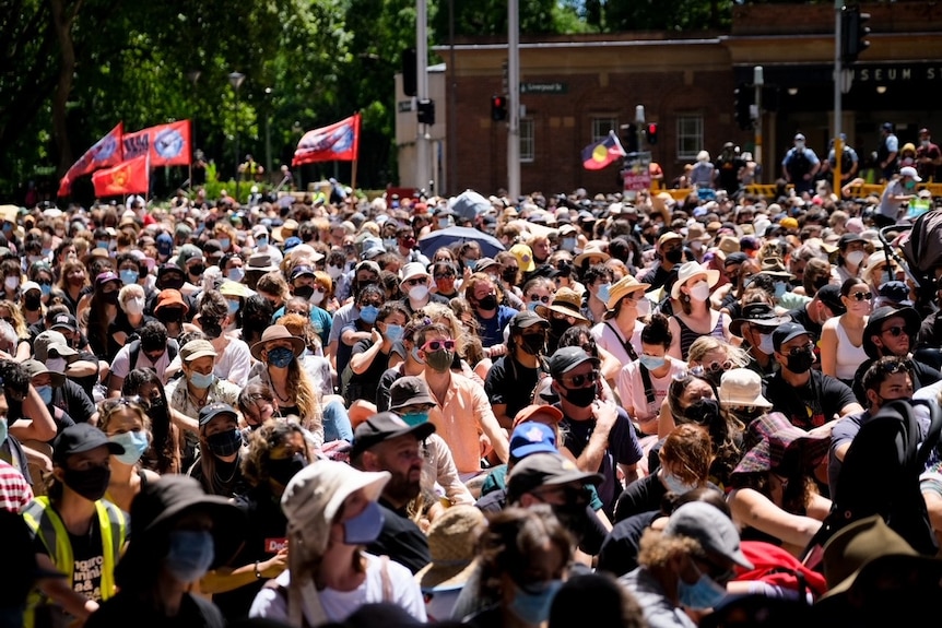 Protesters sit on the ground