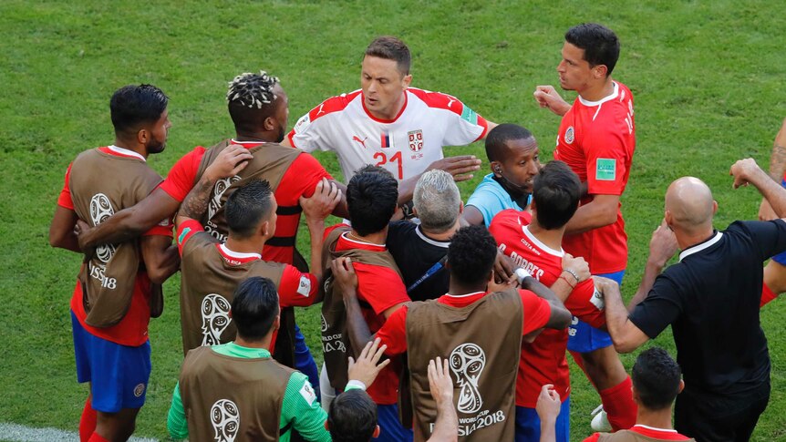 Serbia player Nemanja Matic has push and shove with Costa Rica players while referee shuts it down