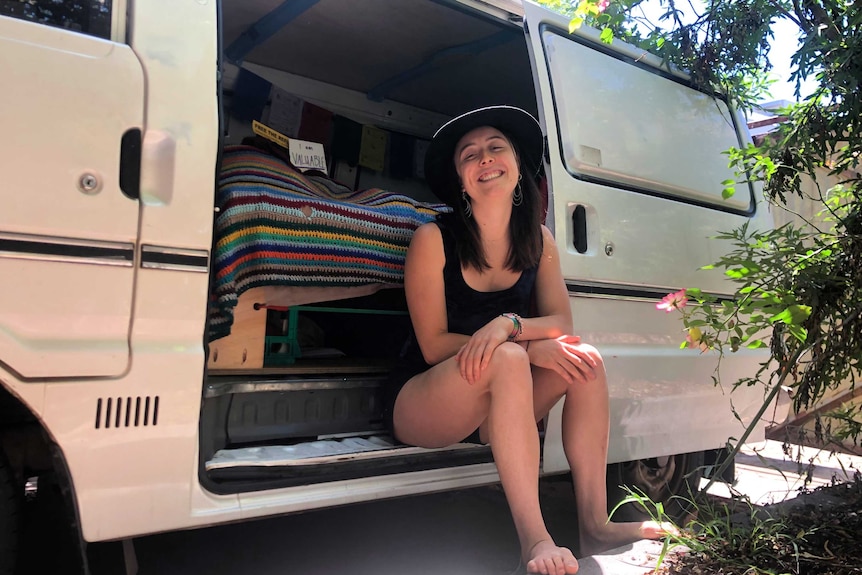 Amelia La Haye in her van in her Melbourne back yard.