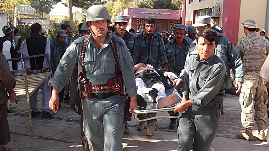 Afghan police carry bombing victim from mosque