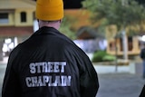 The back of a man's jackets which says 'street chaplain'