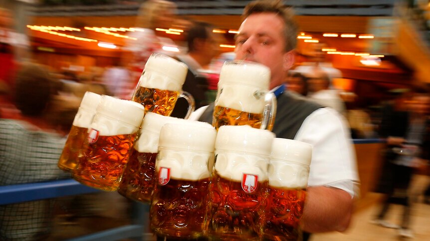 A waiter carries beer at Oktoberfest.