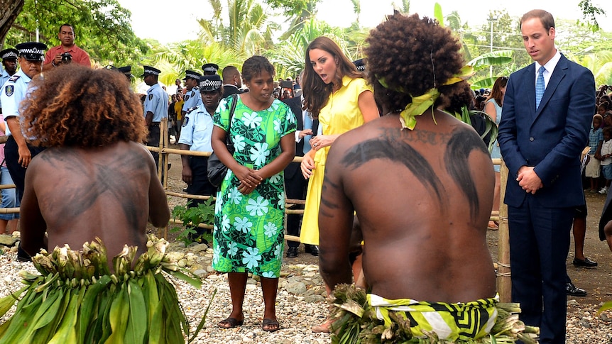 Prince William (R) and the Duchess of Cambridge, watch traditional dancers perform in Honiara, Solomon Islands.