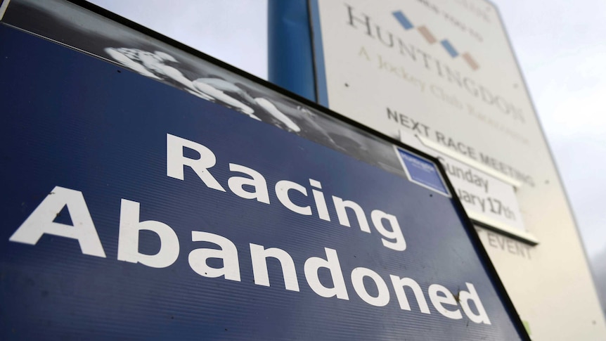 A sign at a racecourse says "Racing Abandoned".