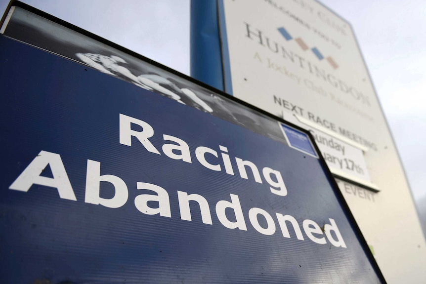 A sign at a racecourse says "Racing Abandoned".
