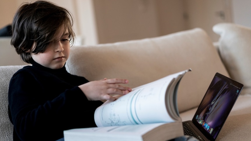 Belgian student Laurent Simons, 9 years old, reading a book.