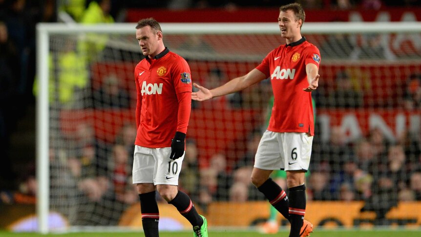 Manchester United's Wayne Rooney and Jonny Evans react after conceding a goal against Spurs.