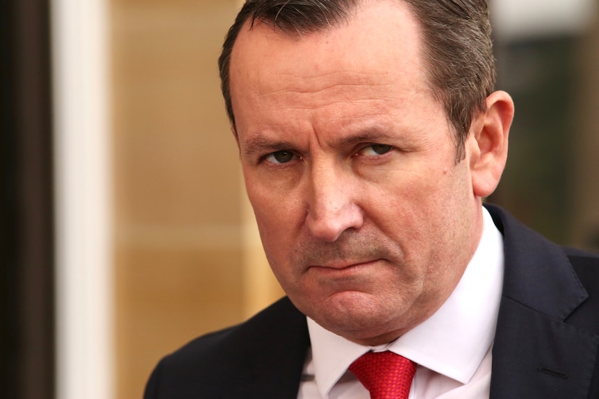 WA Premier Mark McGowan looks intently at someone during a media conference outside Parliament in WA.