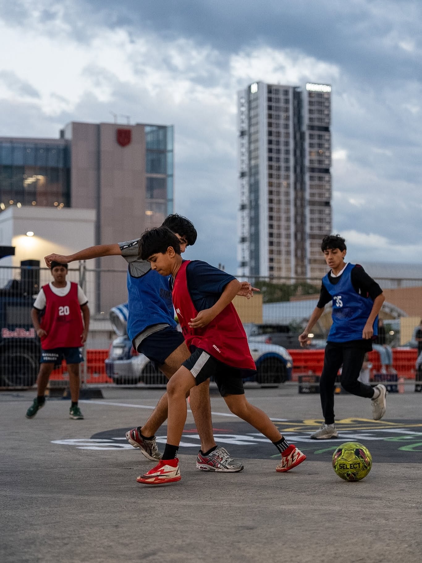 Kids playing football on a car park rooftop