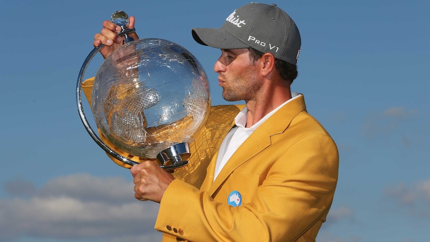 Adam Scott kisses the trophy after winning the Australian Masters title at Royal Melbourne.