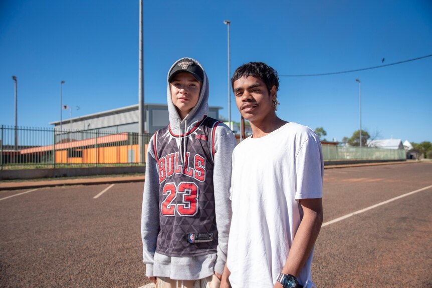 Two young boys stand out the front of the youth centre.