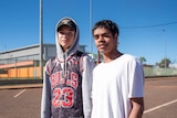 Two young boys stand out the front of the youth centre.
